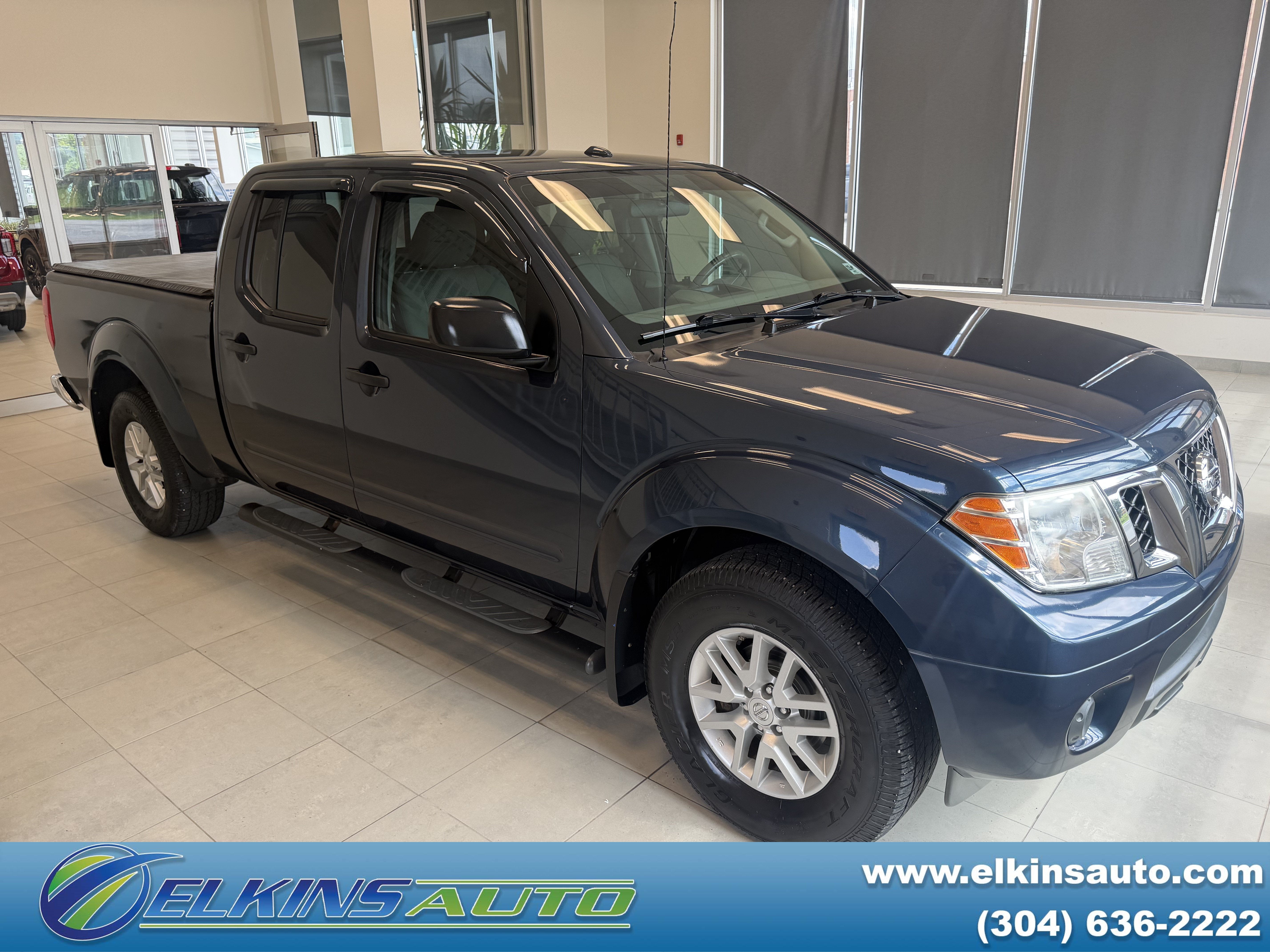 2016 Nissan Frontier SV in Arctic Blue Metallic — front three-quarter view